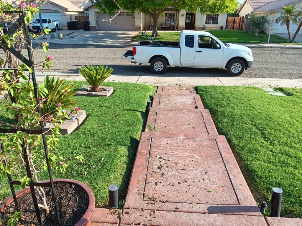 Brick walkway with trimmed lawn edged on both sides in Brawley, CA