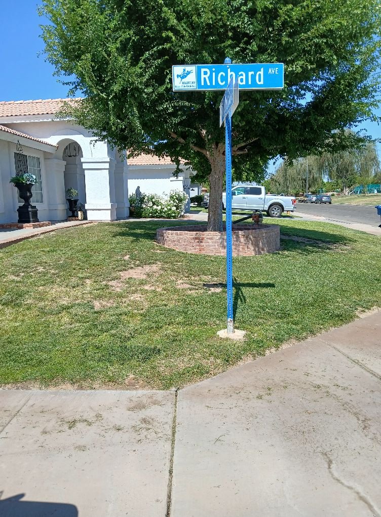 Corner lot lawn mowed and edged at a Brawley, CA street corner