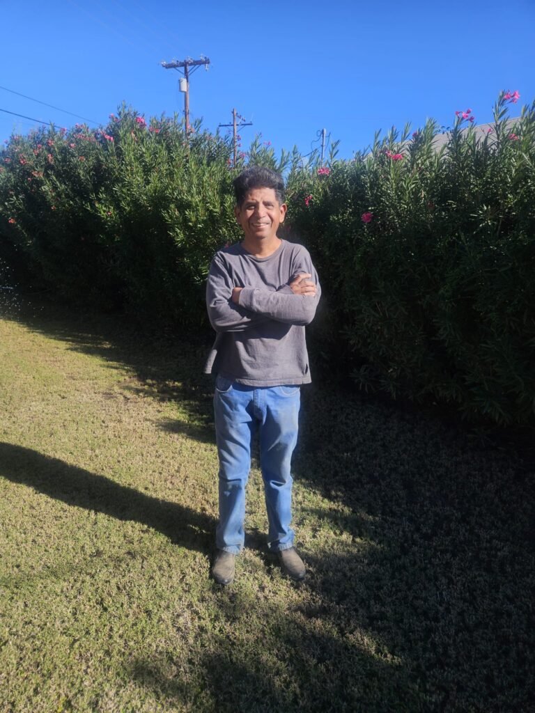 Crisel Salazar, owner of Crisa Landscaping, on a customer lawn in Brawley, CA